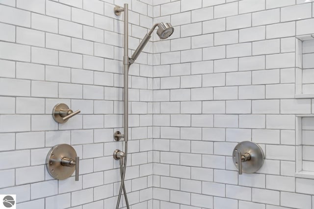 bathroom with tiled shower