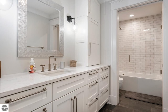 full bath featuring toilet, wood finished floors, crown molding, tub / shower combination, and vanity