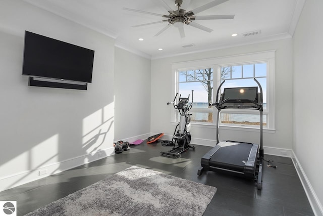 exercise area featuring visible vents, baseboards, and crown molding