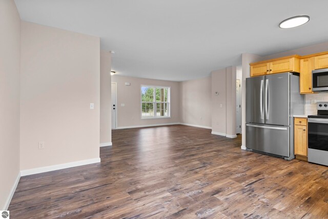 kitchen featuring light brown cabinets, baseboards, dark wood-style flooring, appliances with stainless steel finishes, and backsplash