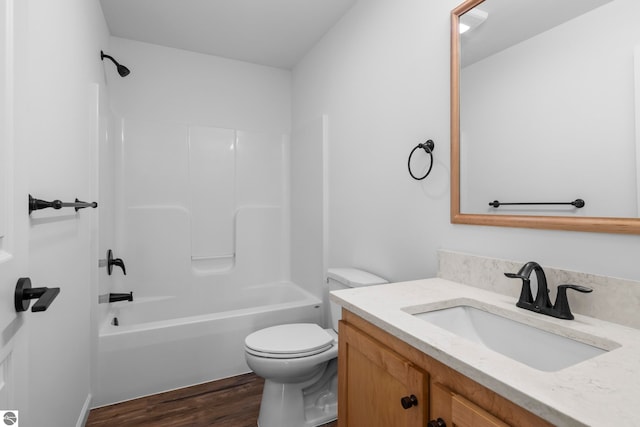 full bath with vanity, bathing tub / shower combination, toilet, and wood finished floors