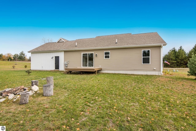 rear view of property featuring a lawn