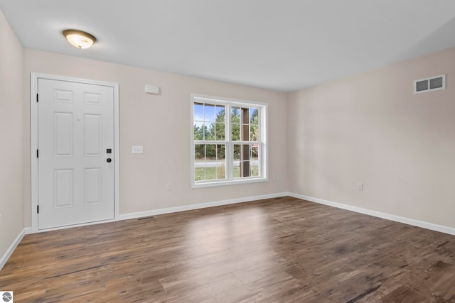 entryway with wood finished floors, visible vents, and baseboards