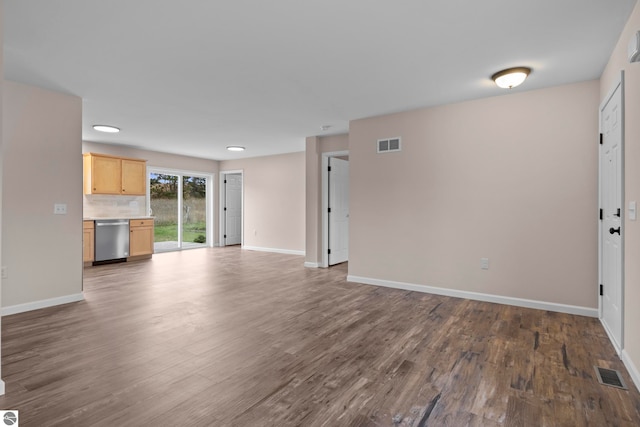 unfurnished living room featuring dark wood-style floors, visible vents, and baseboards