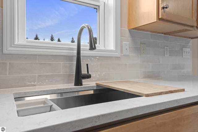 details featuring decorative backsplash and a sink