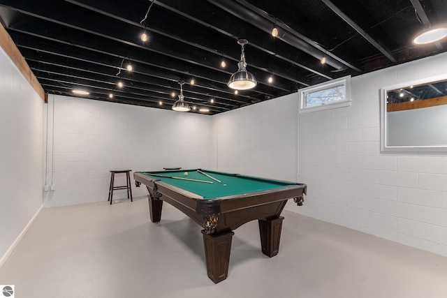 playroom featuring concrete block wall, concrete floors, and billiards