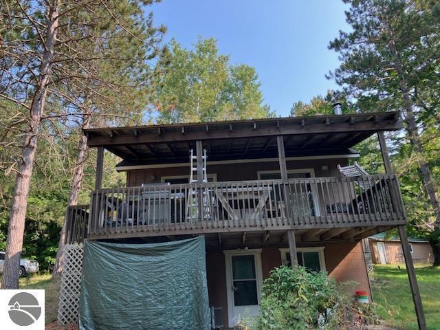 rear view of property featuring a deck