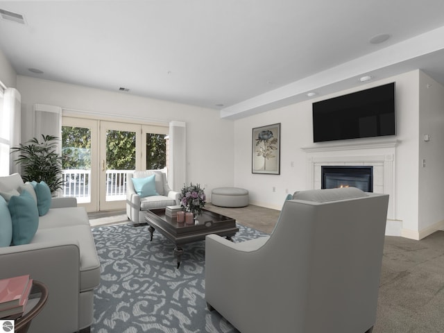 carpeted living room with a glass covered fireplace, baseboards, and visible vents