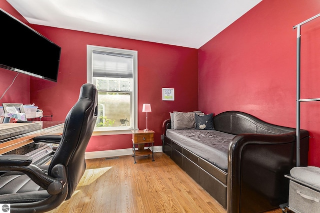 bedroom with baseboards and wood finished floors