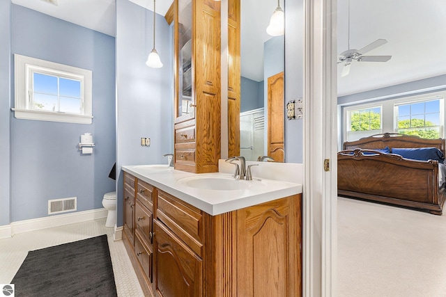 full bath featuring toilet, a ceiling fan, visible vents, and a sink