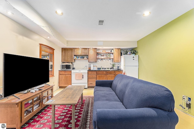 living area featuring recessed lighting and visible vents