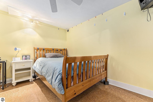 bedroom featuring a ceiling fan, speckled floor, and baseboards