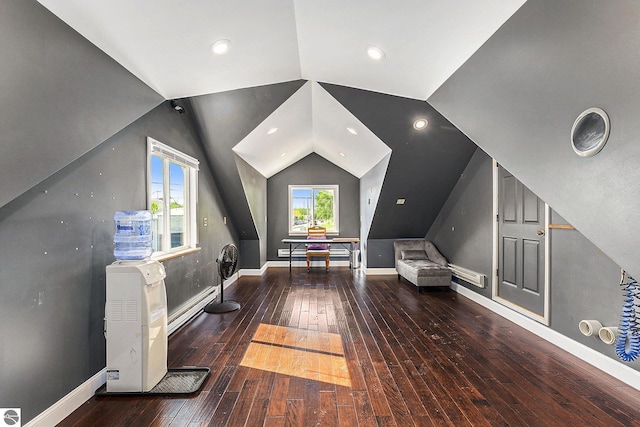 interior space with lofted ceiling, baseboards, and hardwood / wood-style floors