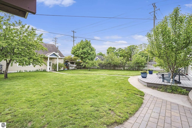 view of yard featuring a wooden deck and fence