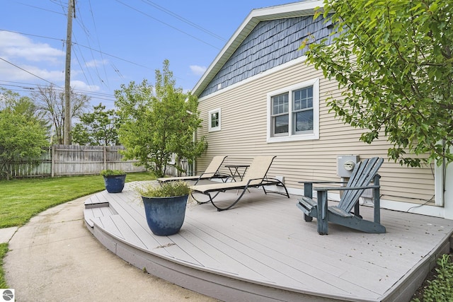 wooden deck with a lawn and fence