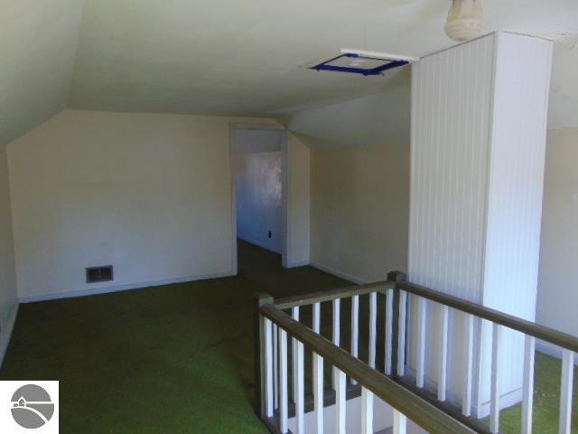 bonus room featuring visible vents, carpet flooring, baseboards, and lofted ceiling