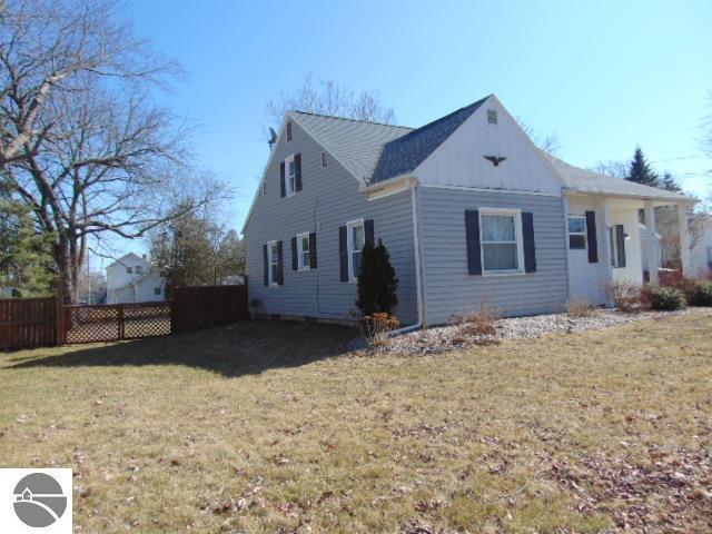 view of property exterior featuring a lawn and fence