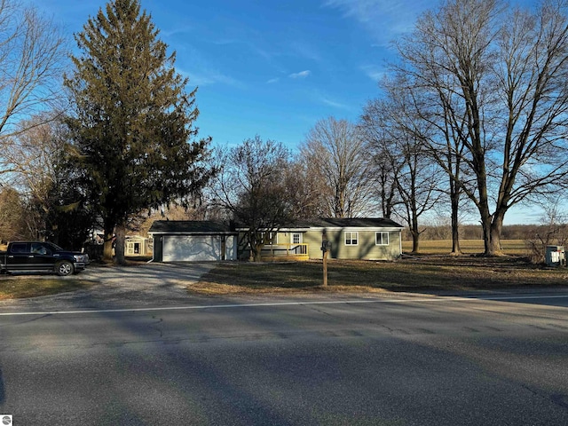 single story home featuring aphalt driveway and an attached garage