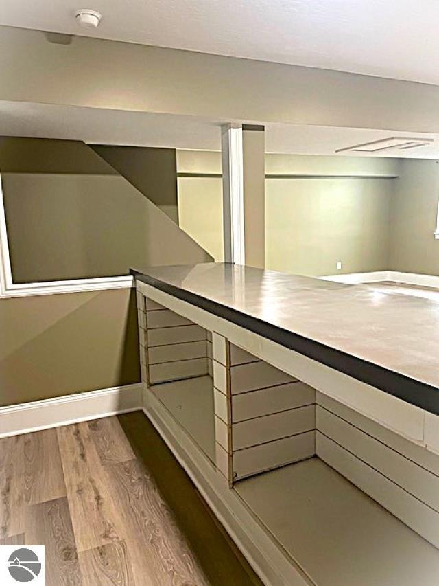 view of sauna / steam room featuring baseboards and wood finished floors