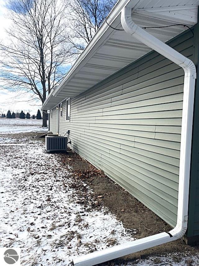 view of snow covered exterior with central air condition unit