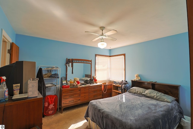 bedroom with a ceiling fan and carpet floors