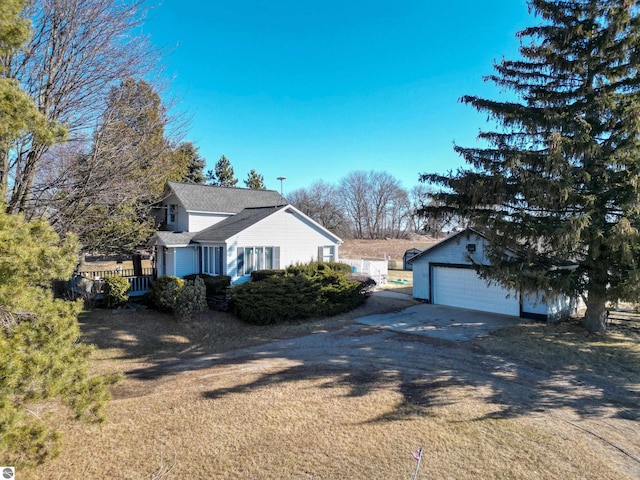 view of home's exterior featuring a detached garage and an outdoor structure