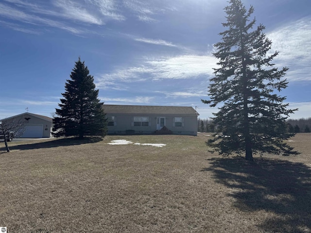 ranch-style home with an outbuilding, a front yard, and a garage