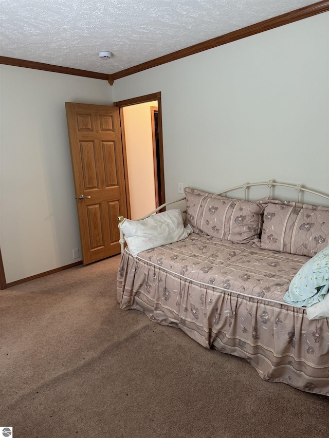 carpeted bedroom with crown molding, baseboards, and a textured ceiling