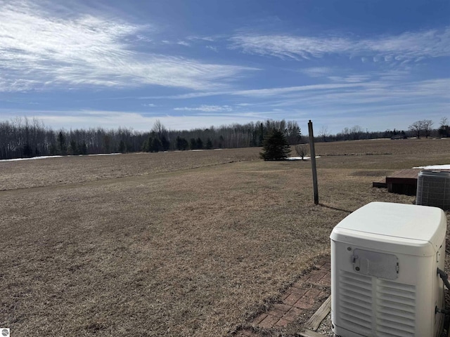 view of yard featuring central air condition unit