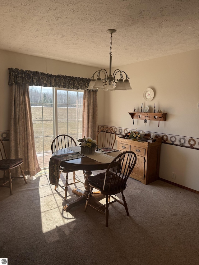 dining space with an inviting chandelier, light colored carpet, baseboards, and a textured ceiling