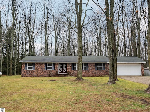 single story home with driveway, a front lawn, an attached garage, crawl space, and brick siding