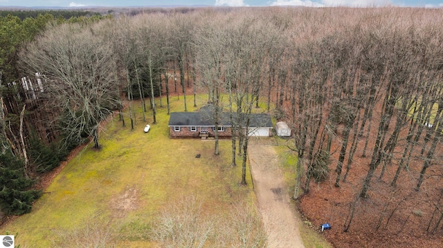 drone / aerial view with a wooded view