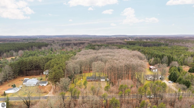 drone / aerial view featuring a forest view