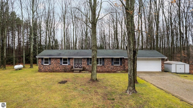 ranch-style house with a front lawn, brick siding, a garage, and driveway