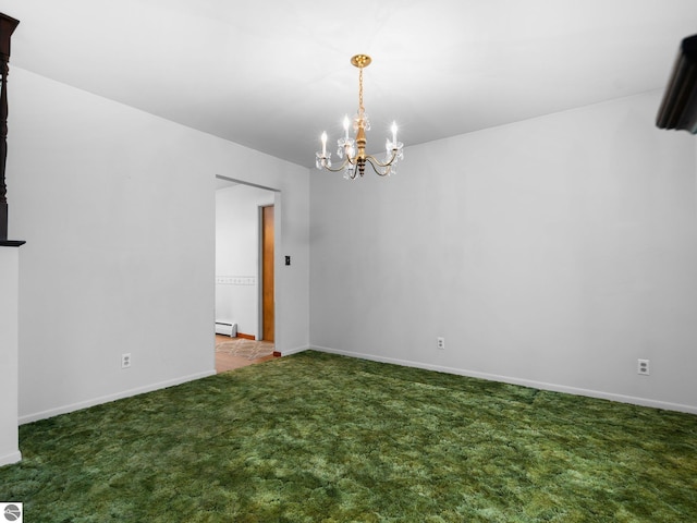 unfurnished room with a baseboard heating unit, baseboards, carpet, and an inviting chandelier