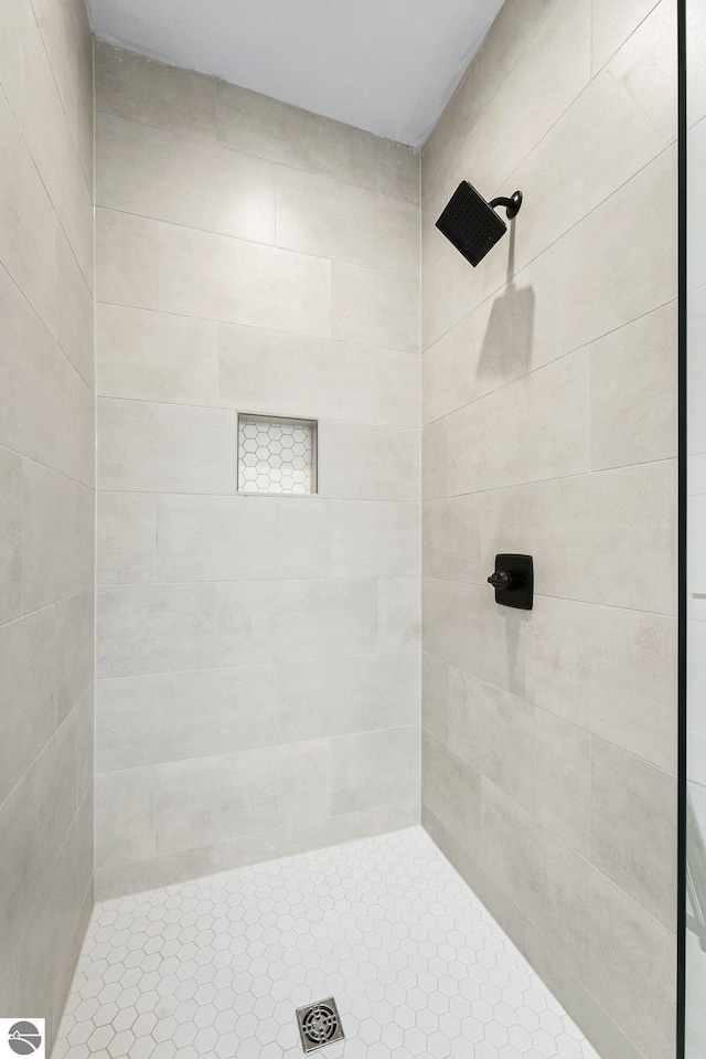 bathroom with a tile shower