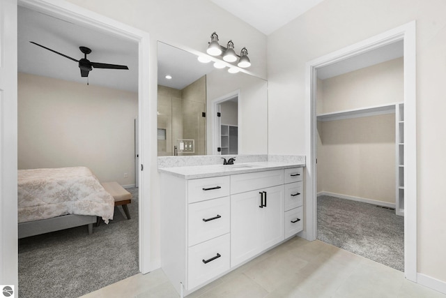 ensuite bathroom with a stall shower, ensuite bath, vanity, ceiling fan, and a spacious closet