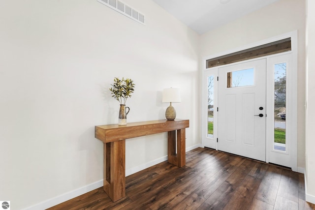 foyer featuring visible vents, baseboards, and dark wood-style floors