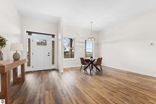 entryway with baseboards and hardwood / wood-style flooring