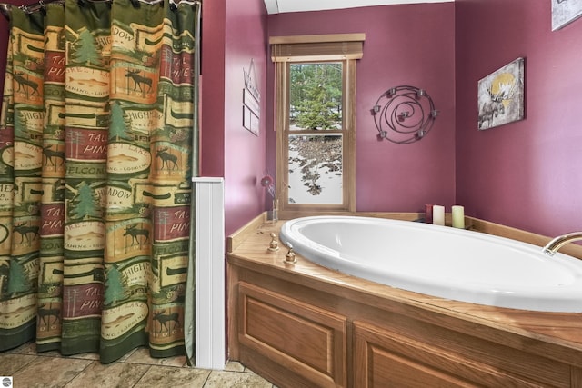 bathroom featuring a bath and tile patterned floors