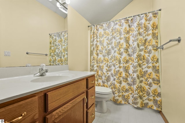 bathroom with vanity, lofted ceiling, toilet, and tile patterned floors