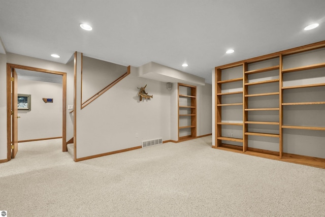 finished below grade area featuring visible vents, recessed lighting, stairway, carpet floors, and baseboards