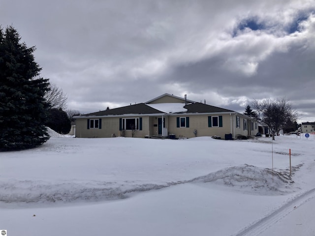 view of snow covered back of property