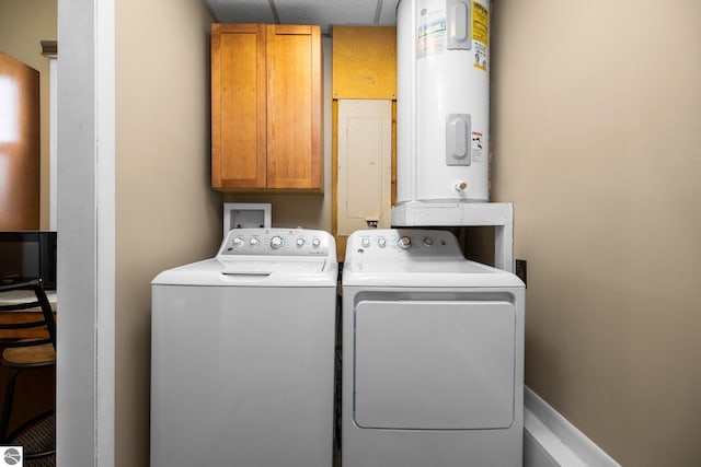 laundry area with cabinet space, electric water heater, and separate washer and dryer