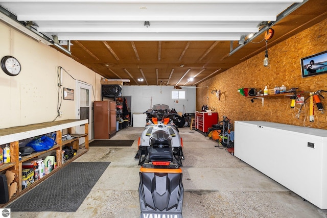 garage with a workshop area and fridge