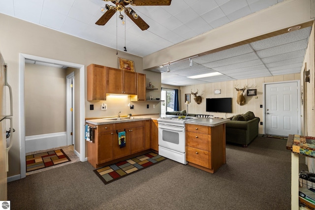 kitchen featuring a peninsula, white electric range, open floor plan, and brown cabinets