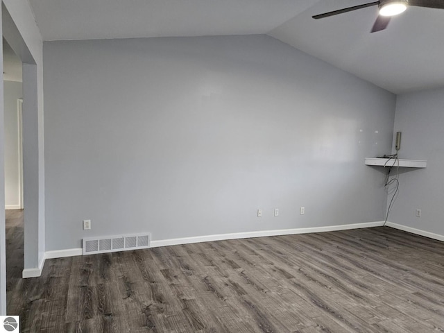 empty room featuring visible vents, a ceiling fan, wood finished floors, baseboards, and lofted ceiling