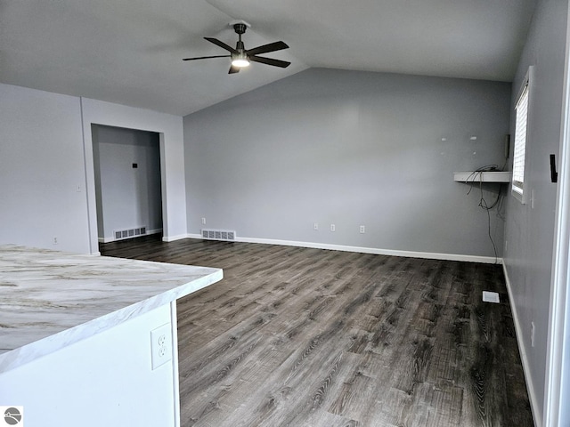 empty room featuring wood finished floors, visible vents, and baseboards