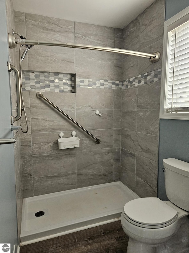 full bathroom with toilet and a stall shower