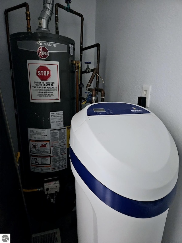 utility room featuring gas water heater